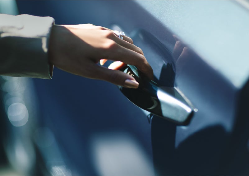 A hand gracefully grips the Light Touch Handle of a 2023 Lincoln Aviator® SUV to demonstrate its ease of use | Mike Carpino Lincoln in Pittsburg KS
