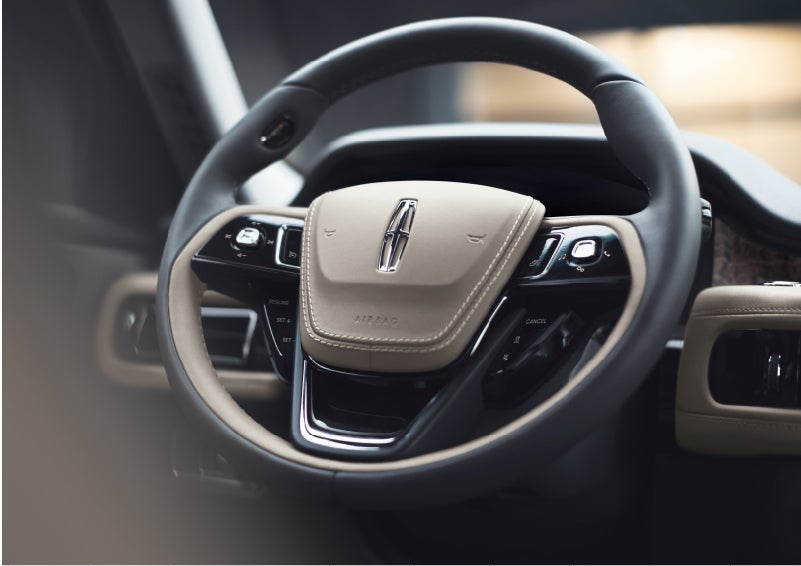 The intuitively placed controls of the steering wheel on a 2023 Lincoln Aviator® SUV | Mike Carpino Lincoln in Pittsburg KS