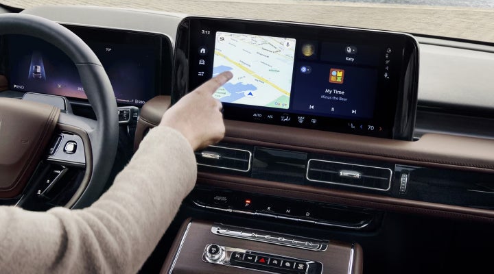A person is tapping the center display touchscreen of a 2026 Lincoln Aviator® SUV. | Mike Carpino Lincoln in Pittsburg KS