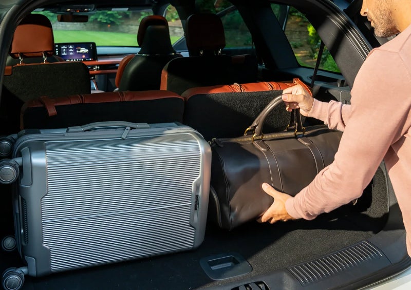 A man loads luggage into the rear of a 2026 Lincoln Aviator® SUV through the opened rear liftgate. | Mike Carpino Lincoln in Pittsburg KS