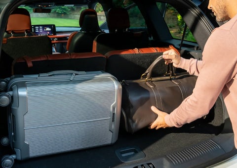 A man loads luggage into the rear of a 2026 Lincoln Aviator® SUV through the opened rear liftgate. | Mike Carpino Lincoln in Pittsburg KS