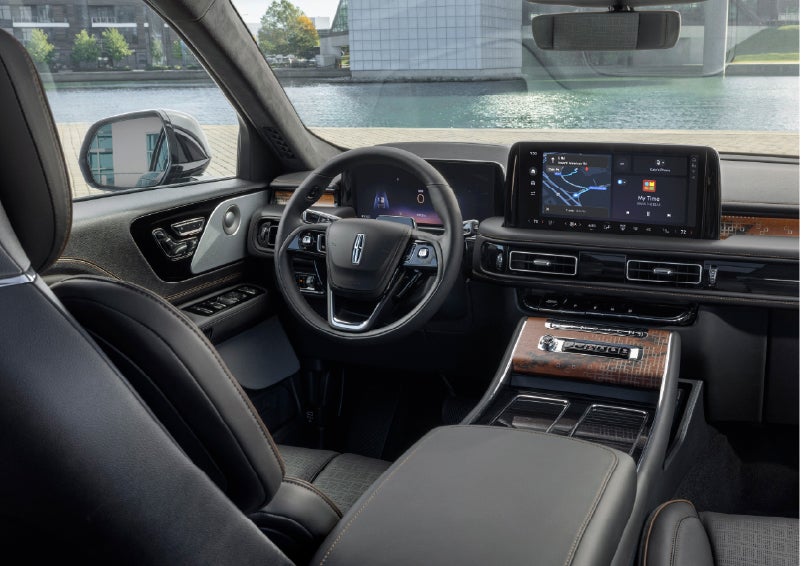 The interior of the 2026 Lincoln Aviator® SUV is shown parked with a view of a harbor through the windshield. | Mike Carpino Lincoln in Pittsburg KS