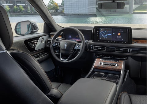 The interior of the 2026 Lincoln Aviator® SUV is shown parked with a view of a harbor through the windshield. | Mike Carpino Lincoln in Pittsburg KS
