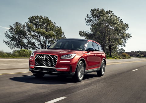 A 2026 Lincoln Corsair® SUV is shown being driven on a country road. | Mike Carpino Lincoln in Pittsburg KS