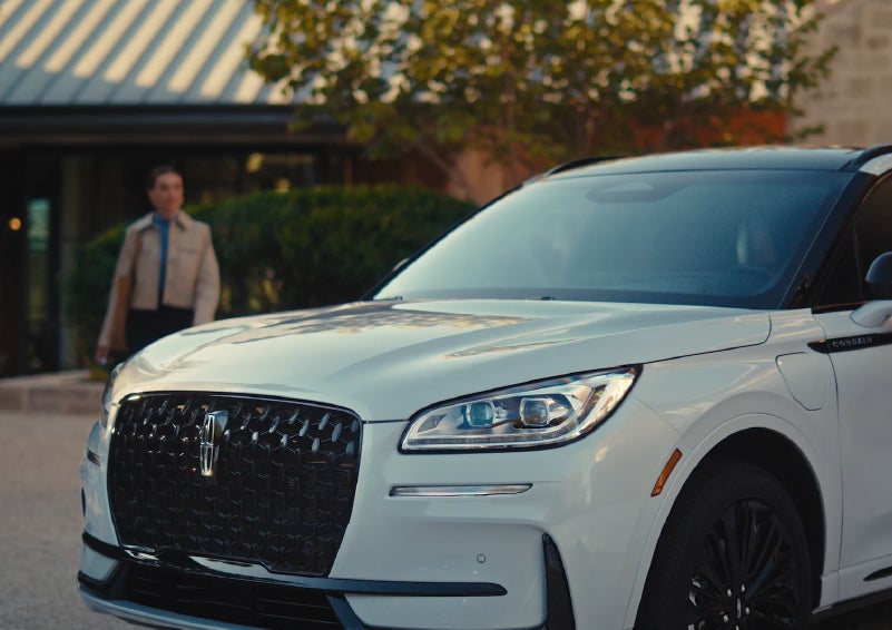 A person approaches a 2026 Lincoln Corsair® SUV as the Lincoln Embrace light sequence takes place. | Mike Carpino Lincoln in Pittsburg KS