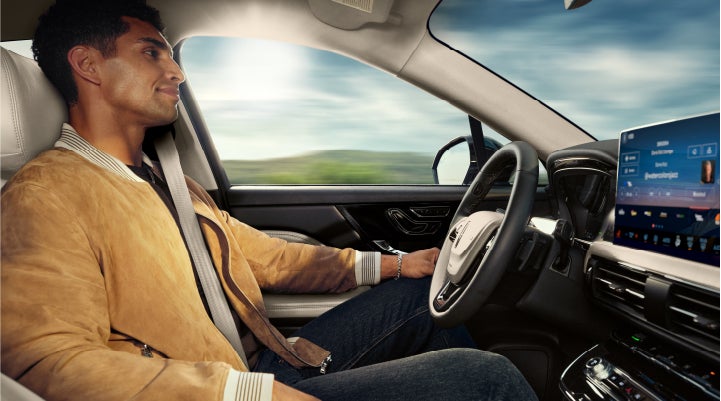 A person is shown using Lincoln BlueCruise hands-free highway driving technology on a divided highway in a hands-free Blue Zone. | Mike Carpino Lincoln in Pittsburg KS