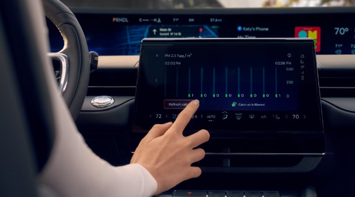 A woman is shown using the Auto Air Refresh feature in the 2026 Lincoln Nautilus® SUV. | Mike Carpino Lincoln in Pittsburg KS