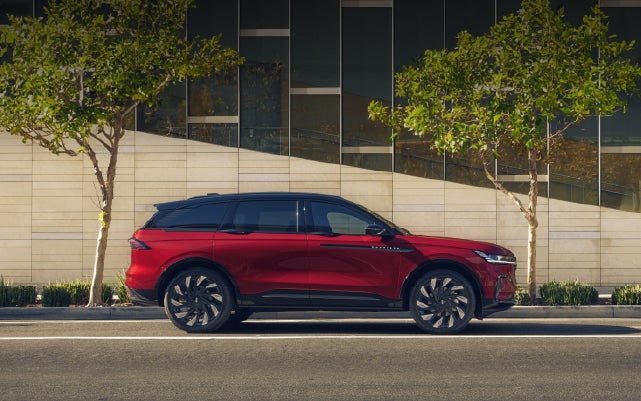 A 2026 Lincoln Nautilus® SUV with an available Hybrid Powertrain is parked in an urban setting. | Mike Carpino Lincoln in Pittsburg KS