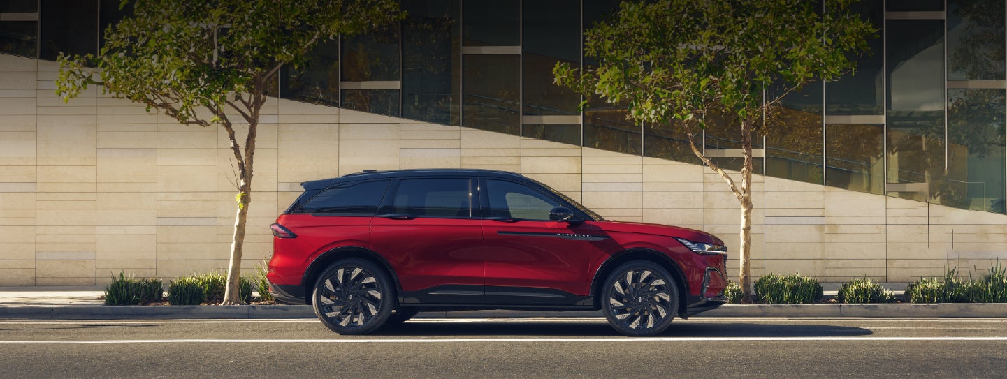 A 2026 Lincoln Nautilus® SUV with an available Hybrid Powertrain is parked in an urban setting. | Mike Carpino Lincoln in Pittsburg KS