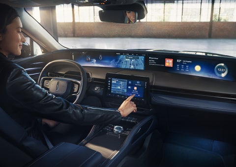 The driver of a 2026 Lincoln Nautilus® SUV interacts with the center touchscreen. | Mike Carpino Lincoln in Pittsburg KS