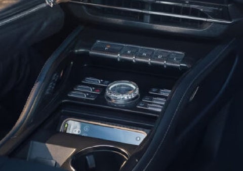 A smartphone is shown charging in the wireless charging pad. | Mike Carpino Lincoln in Pittsburg KS