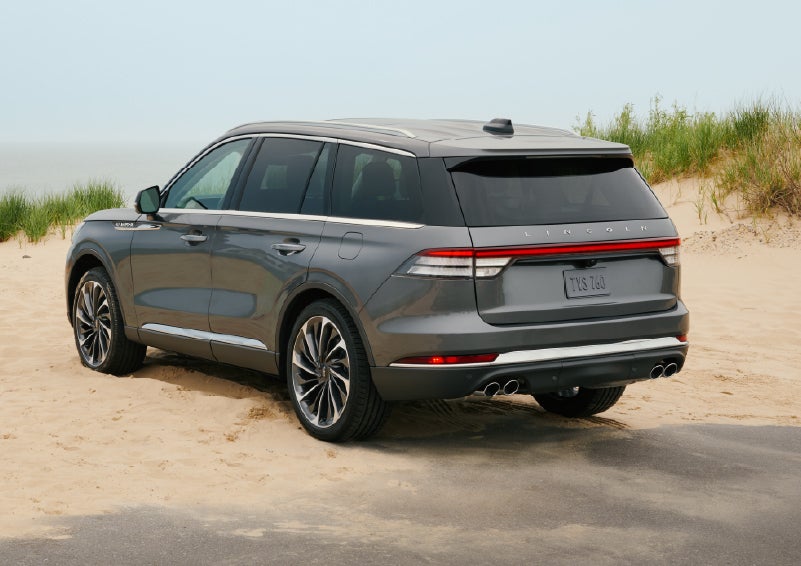 A 2027 Lincoln Aviator® SUV is parked next to sand dunes. | Mike Carpino Lincoln in Pittsburg KS