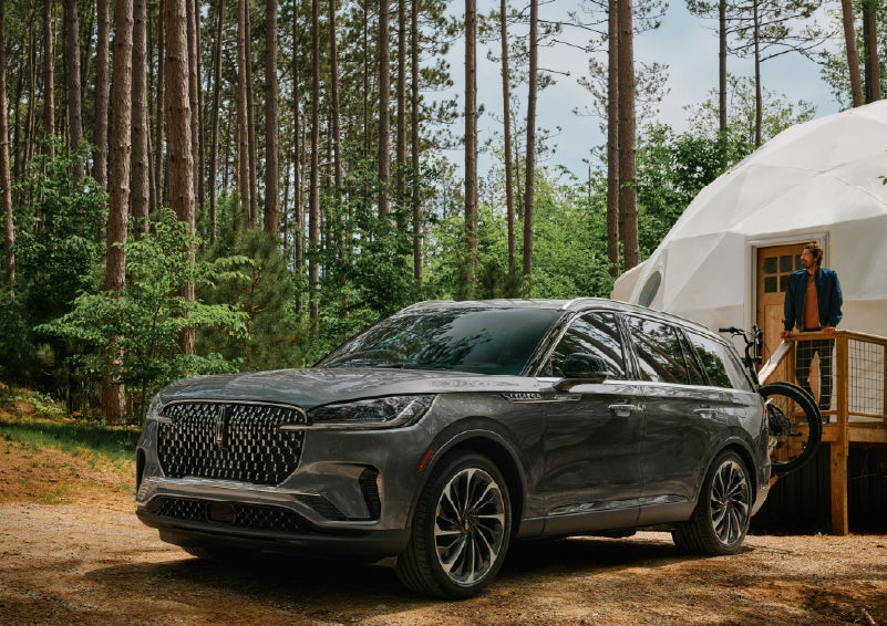 A 2027 Lincoln Aviator® is parked next to a high end glamping site. | Mike Carpino Lincoln in Pittsburg KS