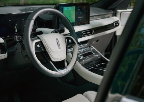 The leather-trimmed steering wheel of a 2027 Lincoln Aviator® Black Label™ SUV. | Mike Carpino Lincoln in Pittsburg KS