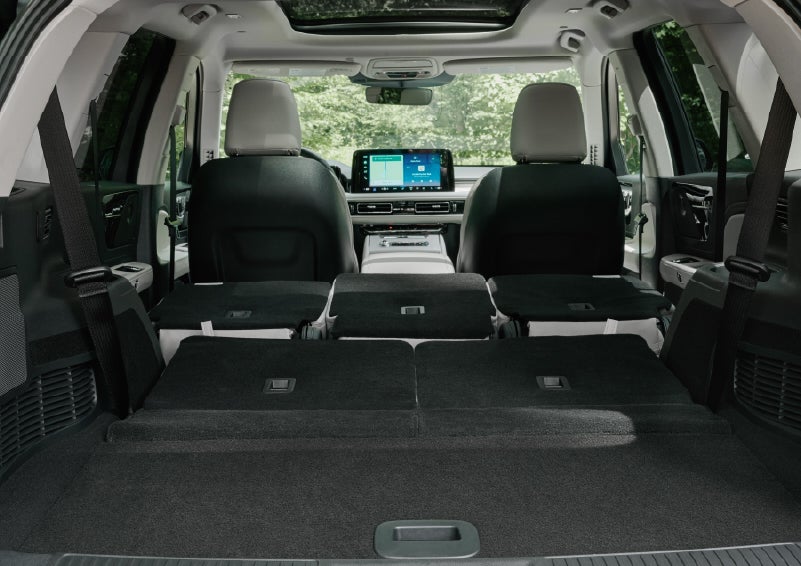 A rear to front view of the interior of a 2027 Lincoln Aviator® Black Label™ SUV shows the third and second rows folded flat | Mike Carpino Lincoln in Pittsburg KS