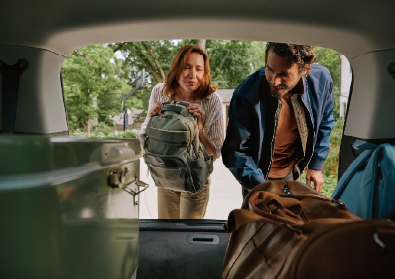 A couple loads luggage into the rear of a 2027 Lincoln Aviator® Black Label™ SUV..e 202 | Mike Carpino Lincoln in Pittsburg KS